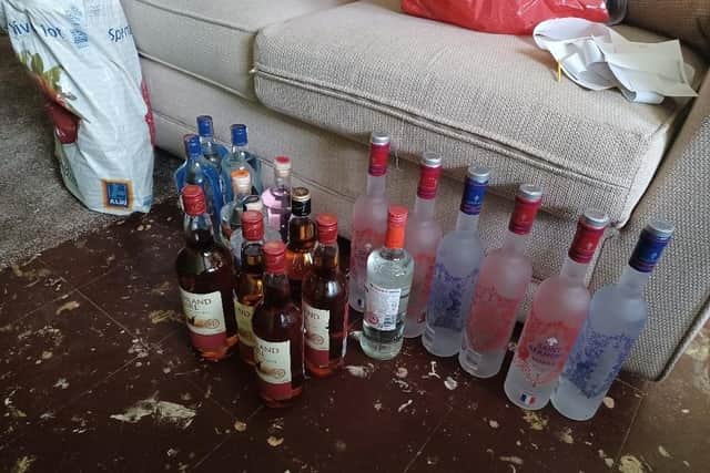 A search of a man's flat, who matched the description of a suspected burglar, found several bottles of alcohol and a collection of security tags. Credit: Nottinghamshire Police