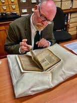 Richard Townsley studies the fascinating book in the cathedral library at Lincoln.