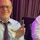 Paramedic Rob Ferrol holds up his UNISON Branch of the Year Award for going above and beyond in the line of duty.