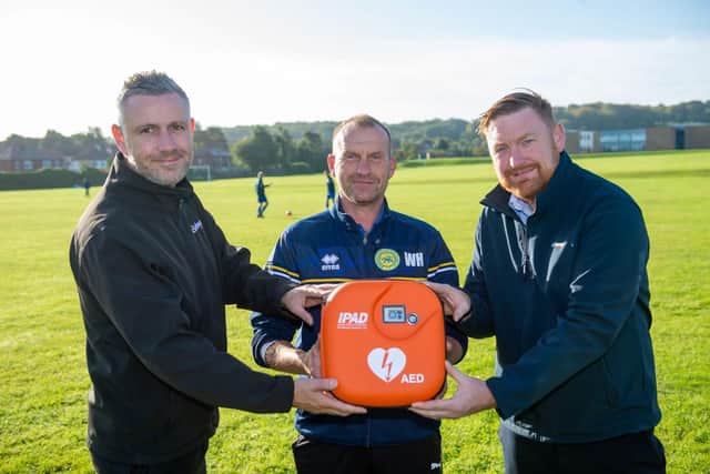 Gary Sidney, Bellway head of construction, Wayne Hulme, manager of the U17’s Pitbulls team, and Andrew Colclough, Bellway site manager with the donated portable defibrillator.