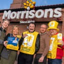Paul Chuckle, with Paul Bayfield Knight and Morrisons staff Credit: Picture It Media