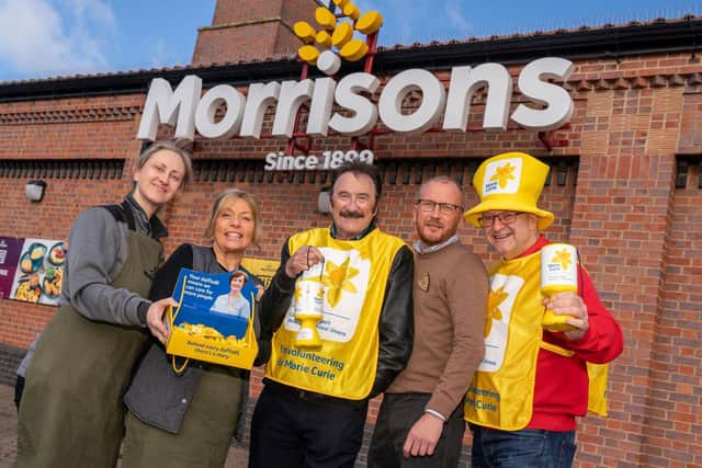 Paul Chuckle, with Paul Bayfield Knight and Morrisons staff Credit: Picture It Media