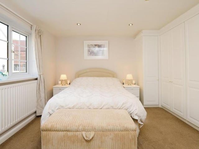A bedroom that has fitted wardrobes to one wall and spotlights. Again, it is a good size.