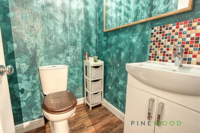 The colourful downstairs toilet at the Whitwell property consists of a low-flush WC and vanity sink unit.
