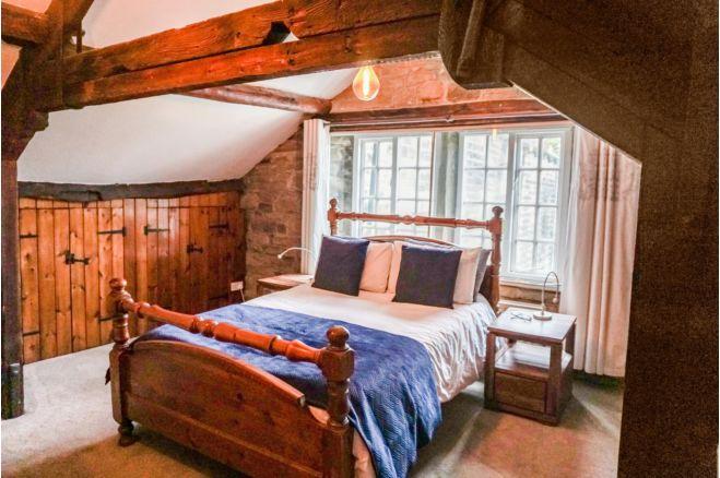 The spacious master bedroom is on the third floor with feature original beams, built in wardrobes in the eves and a further built in wardrobe.