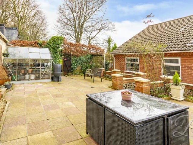 Moving on now to a selection of photos from the bungalow's lovely exterior. This is an extensive paved area that has room for a barbecue, seating and even a greenhouse.