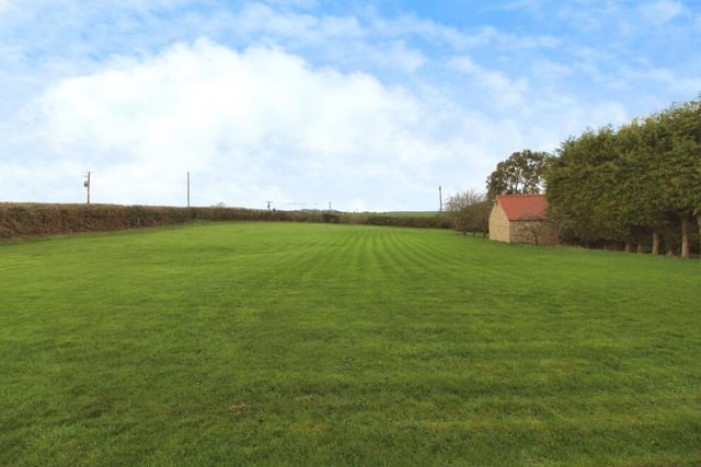 Beyond the rear garden at the £900,000 Elmton farmhouse is a substantial, grassed paddock area.