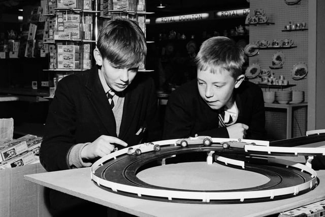 Schoolboys play with a slot-car racing set called Trix in the toy department of Binns department store in November 1965.