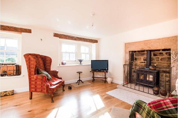 This versatile second reception room has a stone fireplace with inset, log-burning stove. The room has two, double-glazed, sliding sash windows to the front, one having a picture seat.
