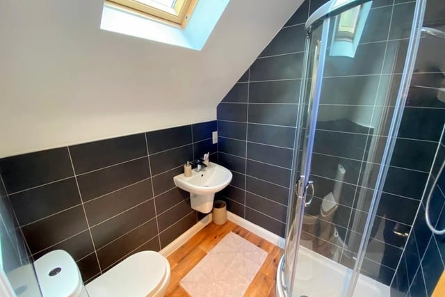 The en suite to the master bedroom is a fine three-piece shower room. It includes a fitted corner shower, a WC and wall-mounted wash basin. There is also a Velux window to the ceiling, a heated towel-rail and an extractor fan.