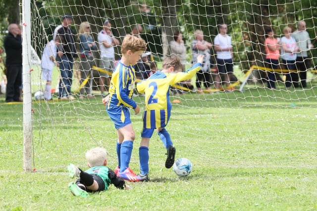 Worksop's Joseph Bailey scores an own goal during a Carcorft Juniors football tournament as Lewis Newton and keeper Alfie Venners watch on.