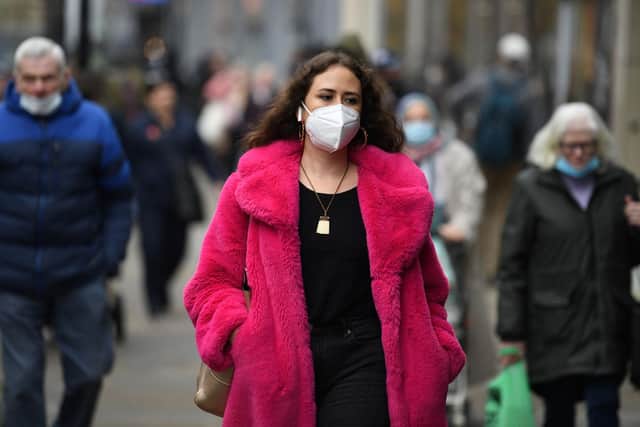 A shopper wears a face-mask (Photo by Oli SCARFF / AFP) (Photo by OLI SCARFF/AFP via Getty Images)