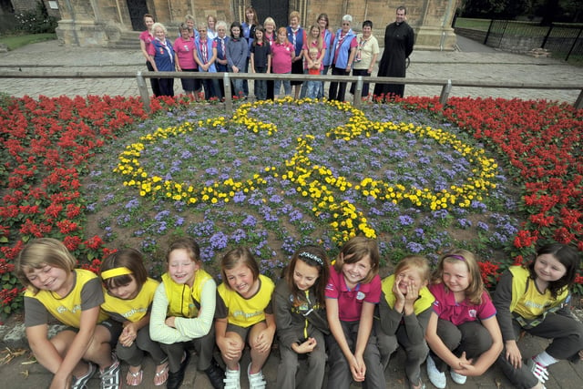 Rainbows, Brownies and Guides from Worksop thank the council for planting flowers in the shape of a trefoil outside Priory Church back in 2010.