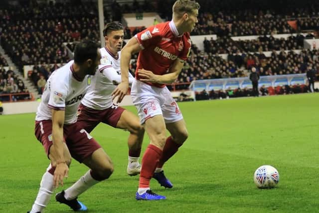 Ryan Yates holds on to possession with two Villa players closing him down