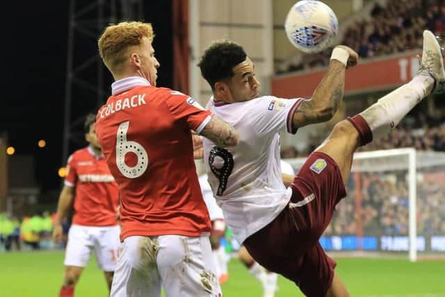 Andre Green hooks the ball clear under close attention from Jack Colback