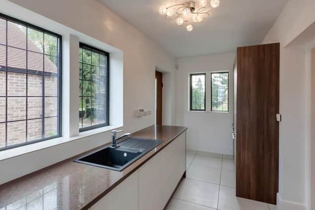 A separate utility room leads off the kitchen