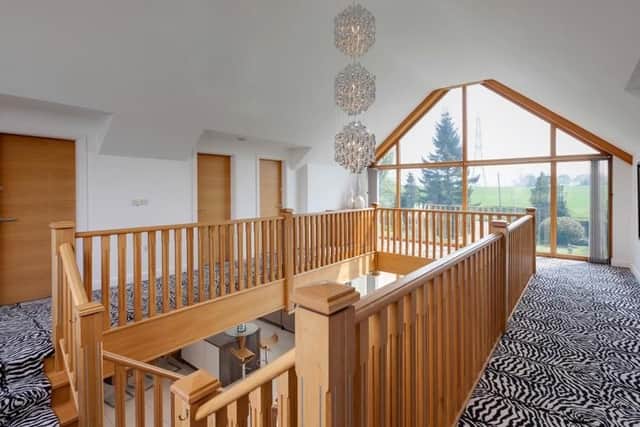 The impressive central staircase leads up to the first floor landing with access to all rooms.