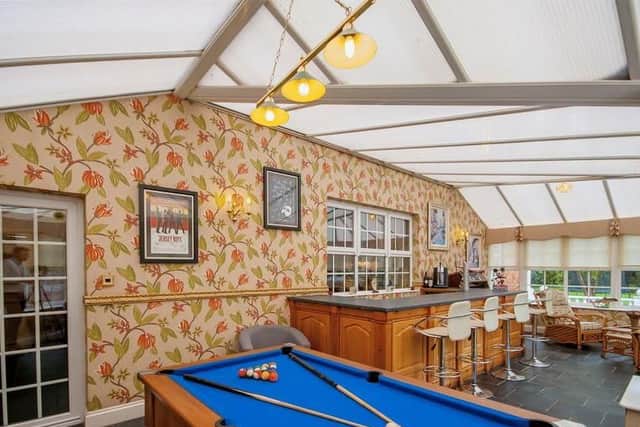 Cue up in the conservatory games area with pool table and bar