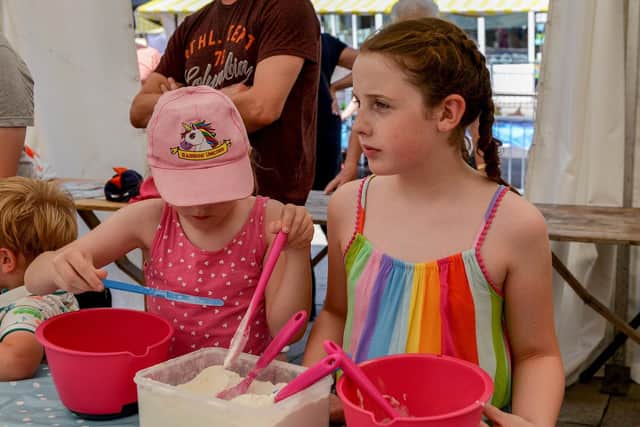 Trying their hand at baking is Isabelle Jones, eight, and Jennifer Anderson, six