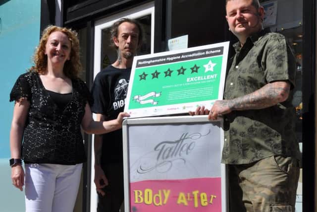 Pictured are Coun Julie Leigh, tattooist Adam Russell and Paddy Kielty.