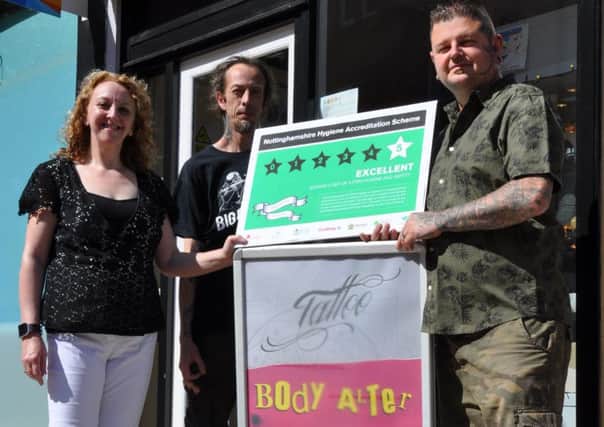 Pictured are Coun Julie Leigh, tattooist Adam Russell and Paddy Kielty.