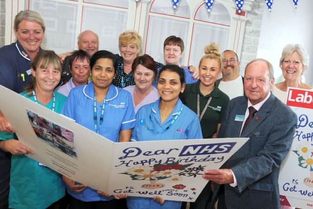 Dave Bond, second right, the chairman of Gainsborough Constituency Labour Party, presents a community birthday card to staff on the Scotter Ward at the John Coupland Hospital on Thursday.