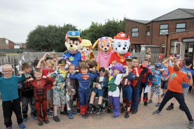 Paw Patrol meet Logan during his 'day' at St George's School, in Gainsborough on Thursday, when his fellow pupils dressed up as their favourite characters as part of a charity fundraiser.