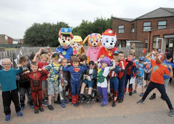 Paw Patrol meet Logan during his 'day' at St George's School, in Gainsborough on Thursday, when his fellow pupils dressed up as their favourite characters as part of a charity fundraiser.