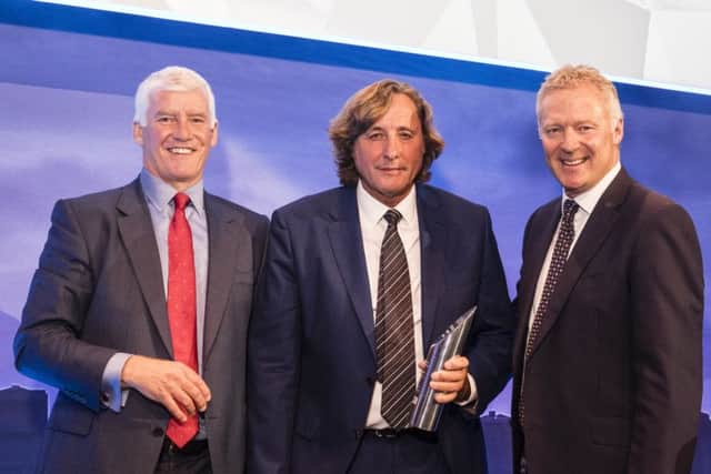 David Mills (centre) gets his award from Rory Bremner and Steve Wood (left)