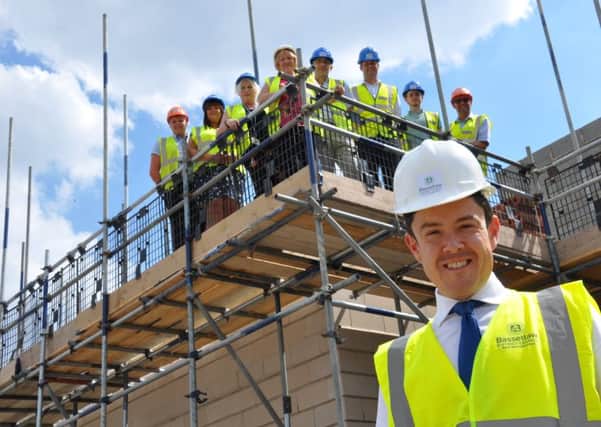 Councillor Simon Greaves, front, and colleagues at the Priory Court development in Lowtown.