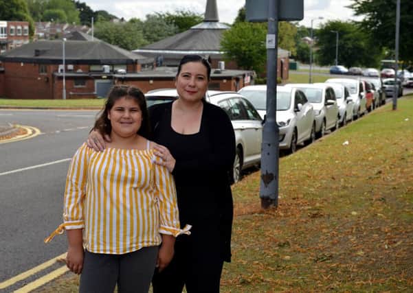 Cars parked along Wingfield Avenue, Worksop are causing problems for cars pulling out of Primrose Way, pictured is Victoria Cristofis and Daughter Chanel Cristofis, 12