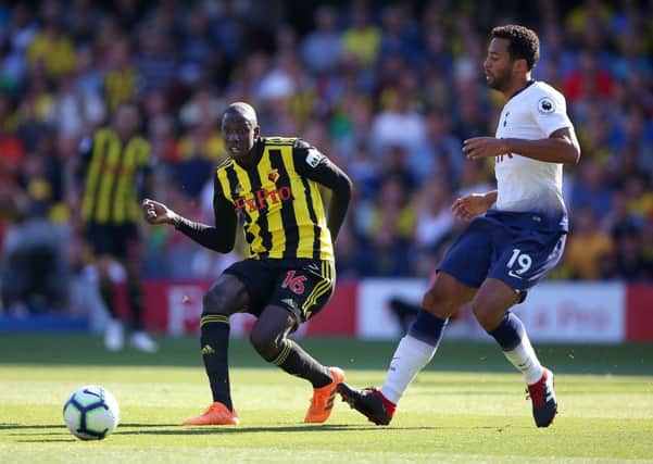 Watford's Abdoulaye Doucoure (left) and Tottenham Hotspur's Mousa Dembele in action during the Premier League match at Vicarage Road.