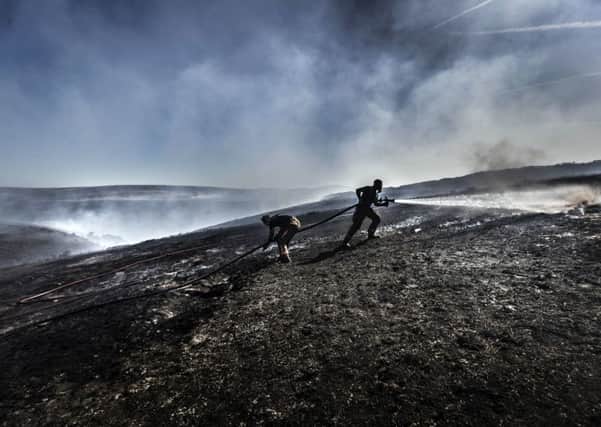 File photo dated 28/6/2018 of firefighters tackle the wildfire on Saddleworth Moor. Firefighters have warned they are under-funded, short-staffed and ill-equipped to deal with an increase in wildfires as new figures show the number of blazes on open ground this summer was more than double the average of previous years.