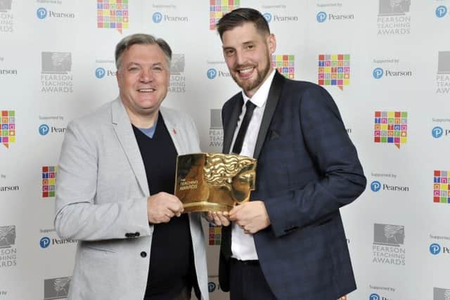 Sam Coy receives the award from Ed Balls