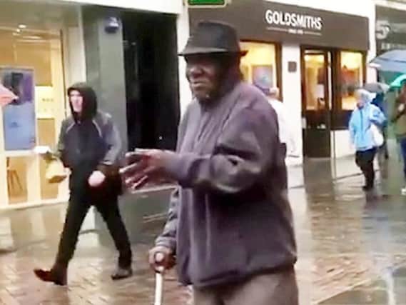 The elderly man was walking past the saxophonist when he stopped and started dancing