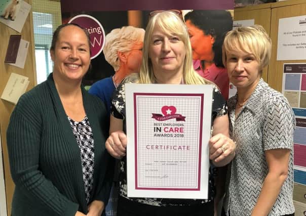Home Instead trio, from left, training and development manager Emma Davey, client support co-ordinator Naomi Young and care manager Kim Yallop, with the award.