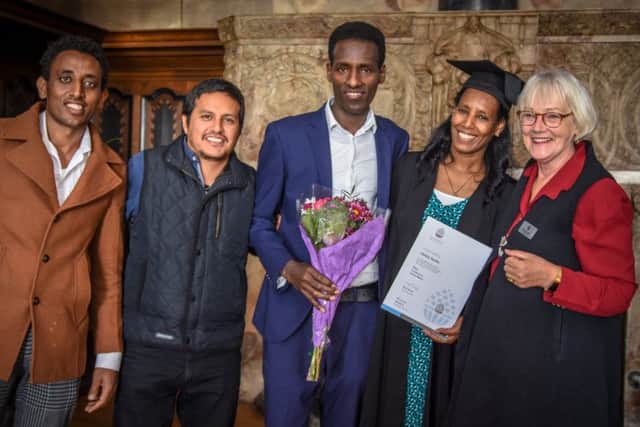 Ghidey Berhane (second right) with family and friends and school founder Alison Parente (right).