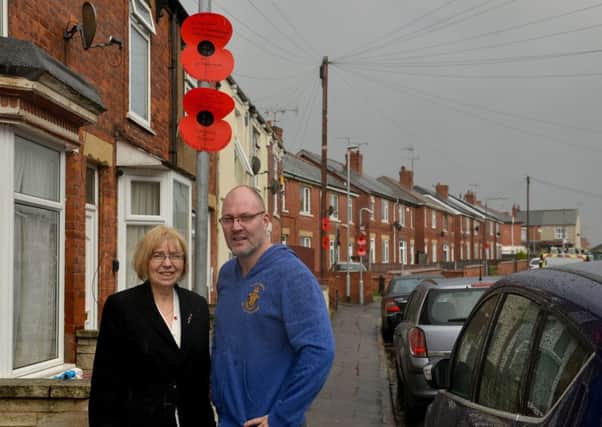 Poppies attached to lamp posts to remember Worksop soldiers of the Great War, pictured is Adie Platts with Coun Sybil Fielding