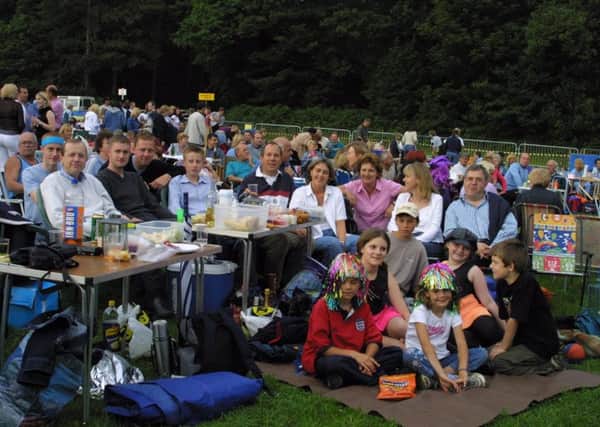 2002: Family and friends gather around tables with their buffet, drinks and goodies ready for a good night at the 60s concert at Clumber Park.