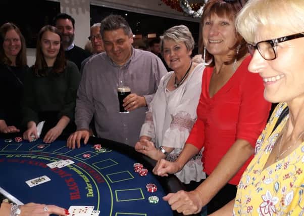 Guests trying their luck at the blackjack table at the Vegas Night.