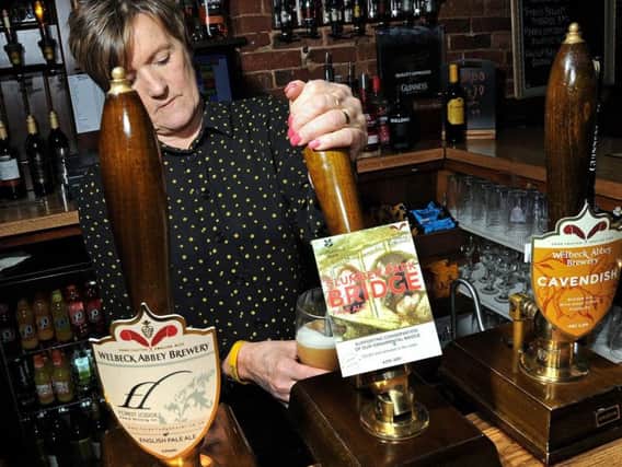 Bev Copestake, the manager at the Forest Lodge Hotel in Edwinstowe, pulls a pint of the Clumber Park Bridge.