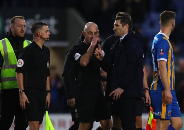 Sam Ricketts speaks with referee Roger East after the FA Cup Fourth Round match between Shrewsbury Town and Wolverhampton Wanderers. (Photo by Catherine Ivill/Getty Images)
