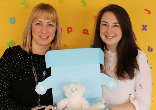 BearHugs founder Faye Savory delivers a hug in a box to Emma Doughty at Bluebell Wood