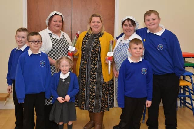 Guardian Rose presentation to school cooks Annette Emmerson and Sarah Coulthard at Langold Dyscarr Community School. Pictured presenting the Rose is KS2 lead teacher Jenny Emery watched by the cooks children