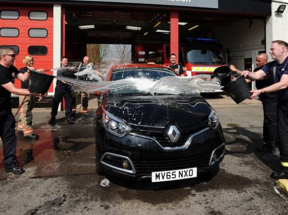 Firefighters took part in a charity car wash to raise money for the Firefighters Charity.