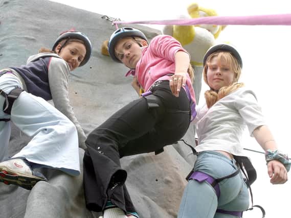 2003: These three girls are enjoying the climbing wall at Whitwell Carnival. Did you have a go at this?