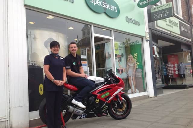Road racer Scott Stone with Karen Allen, store manager at Specsavers in Retford.