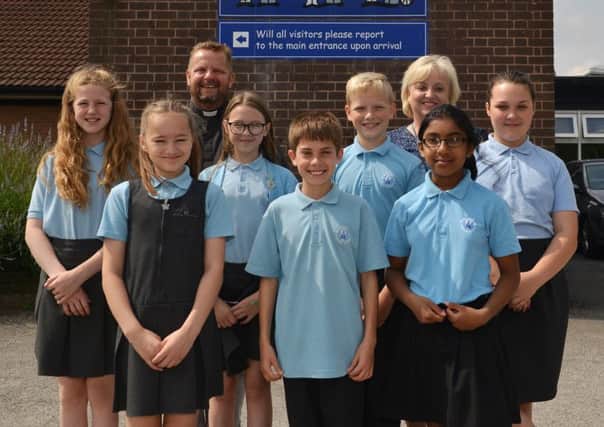 St Anneâ¬"s C of E Primary School have recently been awarded Excellent in a Church schools inspection, pictured are children of the school worship group and school ambassadors with headteacher Clare Middleton and Rev Dave