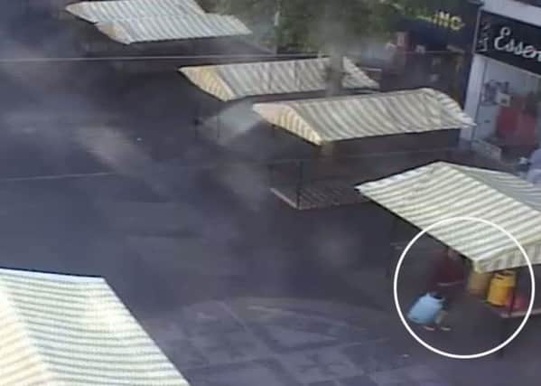 CCTV footage shows market trader Paul Marshall dumping four gas bottles by a stall on Worksop Market.