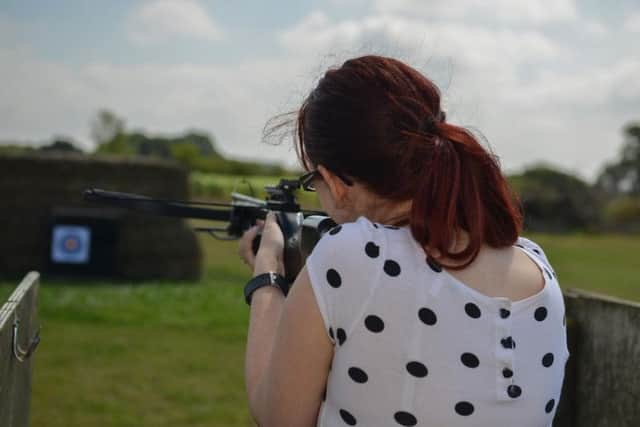 Guardian reporter Shelley Marriott shoots a crossbow